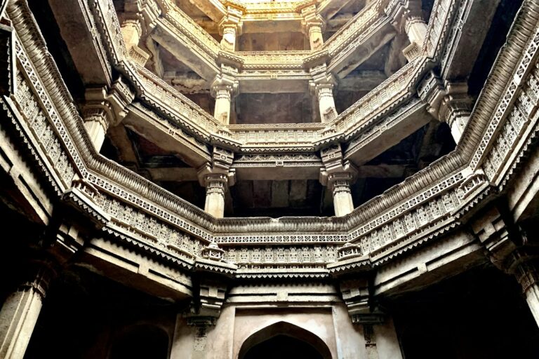 Monumental carved subterranean stone tiers and carved pillars of an ancient Indian stepwell
