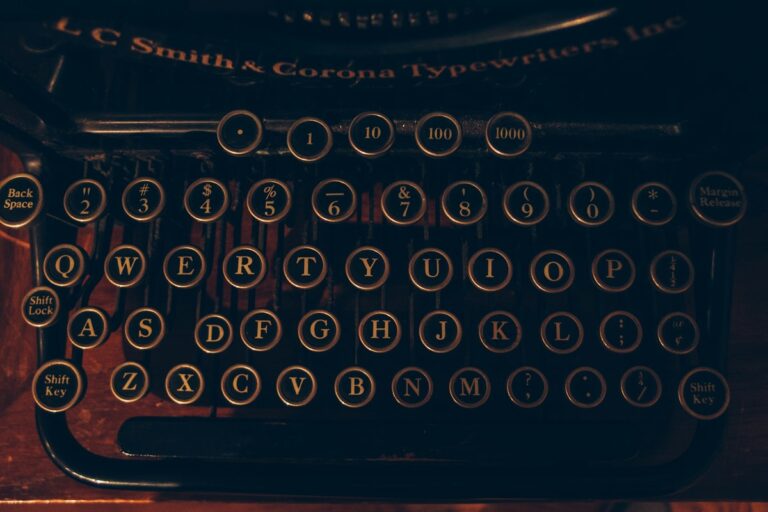 Hands operating vintage typewriter and tactile analog tools