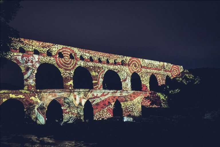 Majestic stone tiers of an ancient Roman aqueduct bridging a river valley with monumental arches