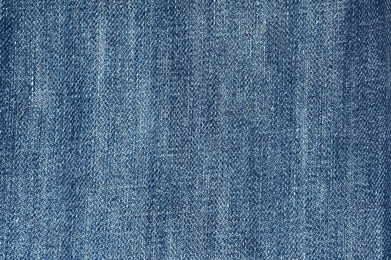 Raw selvedge denim fabric roll showing self-edge identification line and vintage textile weave