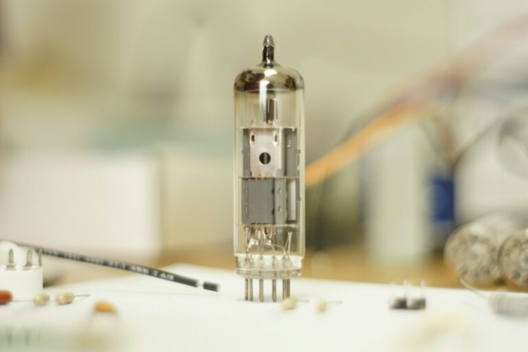 Glowing vintage vacuum tube amplifier displaying thermionic valve filaments and audiophile chassis